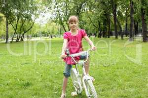 Girl with a bike in the park