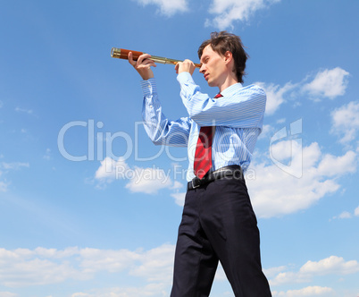 young business man  looks through a telescope