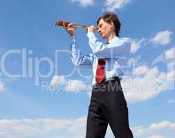 young business man  looks through a telescope