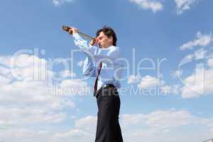 young business man  looks through a telescope