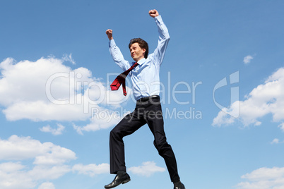 jumping young businessman in a blue shirt