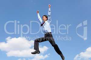 jumping young businessman in a blue shirt