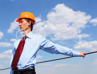 young engineer in a blue shirt and yellow helmet