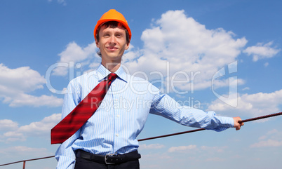 young engineer in a blue shirt and yellow helmet