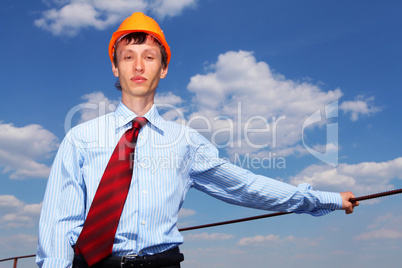 young engineer in a blue shirt and yellow helmet