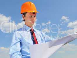 young engineer in a blue shirt and yellow helmet