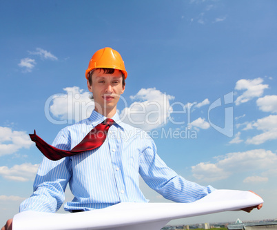 young engineer in a blue shirt and yellow helmet