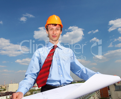 young engineer in a blue shirt and yellow helmet