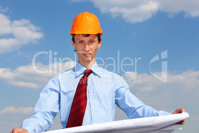 young engineer in a blue shirt and yellow helmet