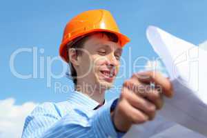 young engineer in a blue shirt and yellow helmet