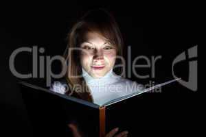 Young woman reading a magic book