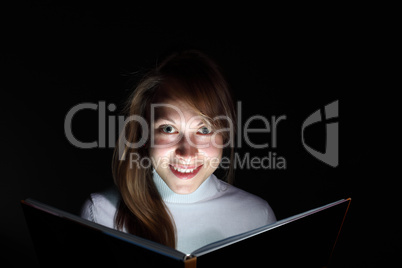 Young woman reading a magic book