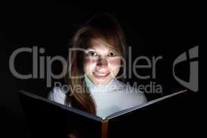 Young woman reading a magic book