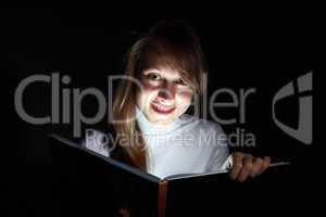 Young woman reading a magic book