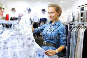 Woman in a shop buying clothes