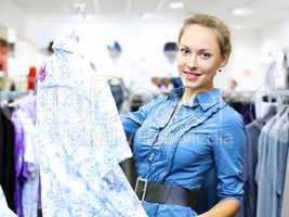 Woman in a shop buying clothes