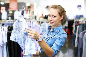 Woman in a shop buying clothes