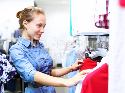 Woman in a shop buying clothes