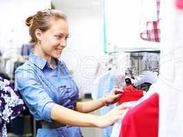 Woman in a shop buying clothes