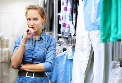 Woman in a shop buying clothes