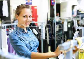 Woman in a shop buying clothes