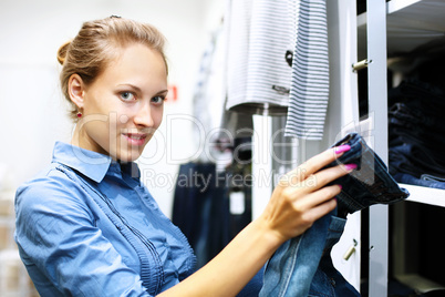 Woman in a shop buying clothes