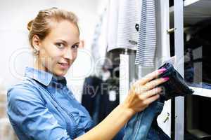 Woman in a shop buying clothes