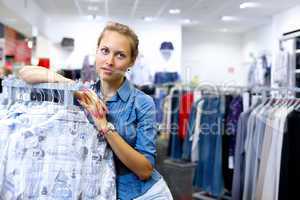 Woman in a shop buying clothes