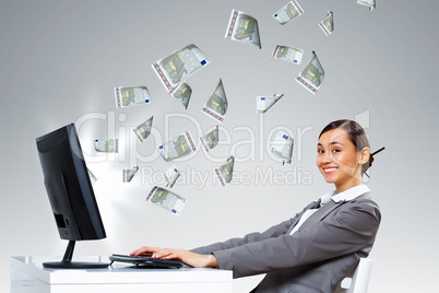 Businesswoman  at workplace and money symbols