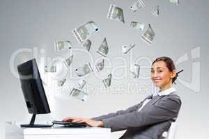 Businesswoman  at workplace and money symbols