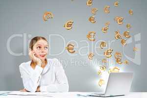 Businesswoman  at workplace and money symbols