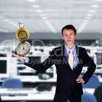 businessman in office holding clock pyramid