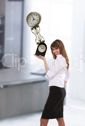 businesswoman in office holding clock pyramid