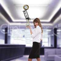 businesswoman in office holding clock pyramid