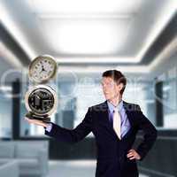 businessman in office holding clock pyramid