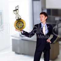 businessman in office holding clock pyramid