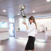 businesswoman in office holding clock pyramid