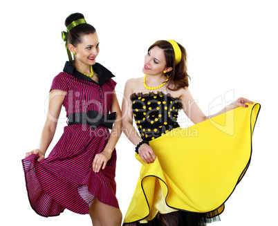 two young woman in bright colour dresses
