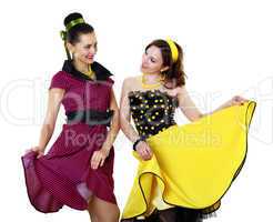 two young woman in bright colour dresses