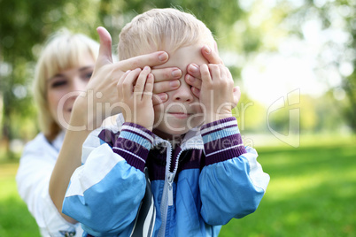 Young mother with her son in summer park