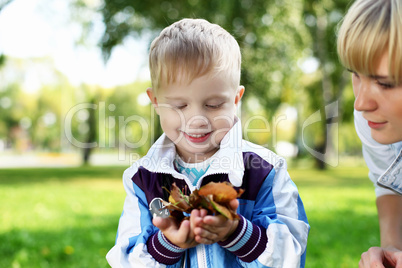 Young mother with her son in summer park