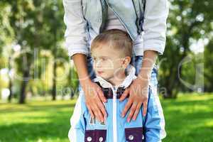 Young mother with her son in summer park