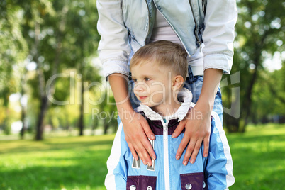 Young mother with her son in summer park