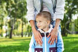 Young mother with her son in summer park