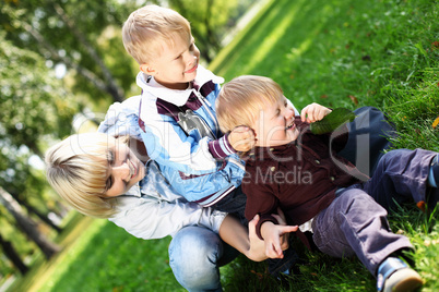 Young mother with her son in summer park