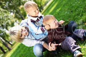 Young mother with her son in summer park