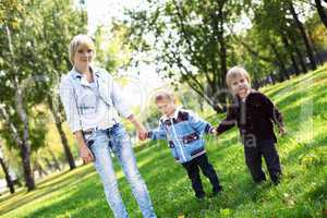 Young mother with her son in summer park