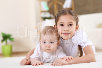 older sister playing with a toddler sister