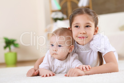 older sister playing with a toddler sister