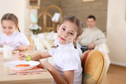 little girl at home having meal